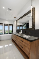 Every bathroom is a retreat, featuring elegant finishes and space for refreshing after beach adventures.