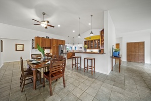 Shaded wraparound lanai with lounge and dining seating, perfect for morning coffee or evening breeze.