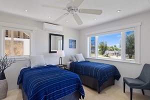 The downstairs guest bedroom has two twin beds and panoramic views.