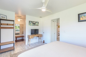 Primary bedroom equipped with a workspace and room to unpack and settle in.