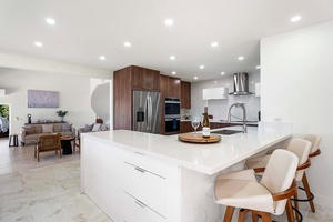 Kitchen island/bar for quick meals and entertainment—ideal for casual breakfasts or social cooking.