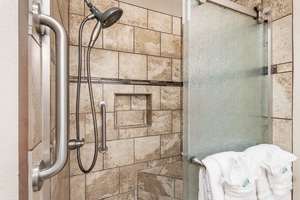 Step into a warm, inviting shower with elegant tilework and a glass enclosure – perfect for unwinding after a day of island adventures.