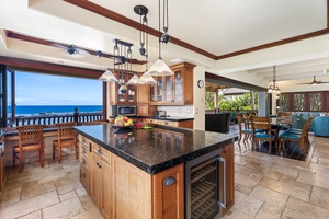 Expansive kitchen island with wine fridge and pendant lighting—ideal for prepping meals or gathering casually.