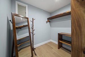Keep everything tidy with a dedicated storage area offering open shelving and hanging space.
