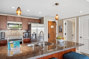 Honua Kai Konea 204 features a chef-ready kitchen with cherry cabinetry and stainless steel appliances.