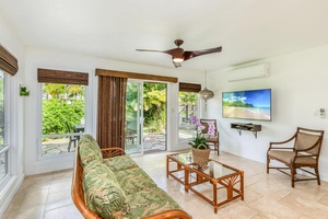 Open the sliding doors to blend indoor comfort with fresh tropical breezes and views of lush greenery.