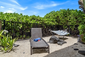 Private sand nook at the edge of the property—relax under palms with toes in the sand.