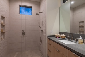 This modern bathroom showcases a sleek and functional design, featuring a spacious walk-in shower.