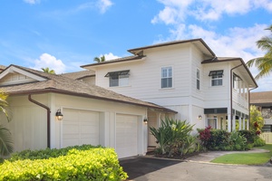 Outside view of the two-story home with a spacious garage and lush landscaping.