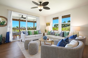 Gather in the bright living room, where large windows frame lush golf course scenery and sliding doors connect you seamlessly to the outdoors.