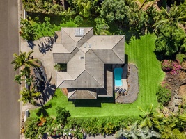 Aerial shot of the home reveals its private placement among tropical landscaping and spacious grounds.