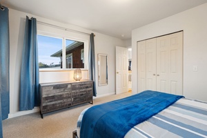Rest easy in your bright bedroom with coastal blue touches, plenty of storage, and peaceful neighborhood views through your window.