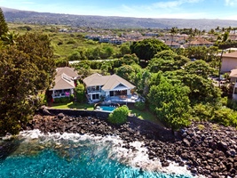 Aerial view of your private oceanfront escape—tucked into Kona’s lush, coastal lava cliffs.