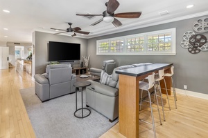 Entertainment-ready media room featuring a flat-screen TV and cozy seating.