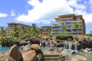 Tropical landscaping and waterfalls create a serene atmosphere steps from Honua Kai Konea 230.