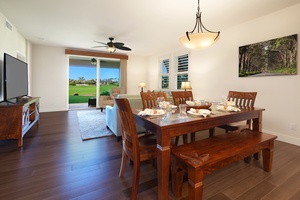 Gather around your elegant dining table with golf course views through sliding doors, perfect for memorable meals.