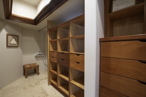 Your spacious walk-in closet offers custom wood shelving and drawers for organized luxury living.