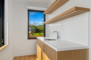Your personal kitchenette in the media room features warm wood cabinetry and a mini fridge with pristine sunset views.