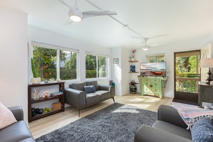 Main living area filled with natural light, complete with Smart TV and comfortable seating for your group.