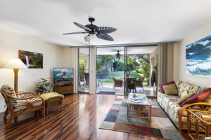 Large sliding glass doors lead to your lanai, blending indoor comfort with Hawaii’s serene outdoor lifestyle.
