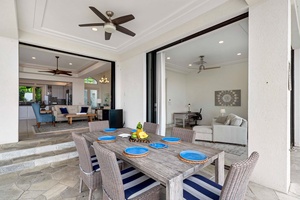 Al fresco dining table beside the pool with direct access to the indoor living space.