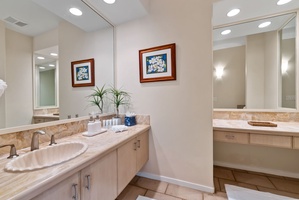 Pamper yourself in this elegant dual-vanity bathroom with marble countertops and thoughtful touches.