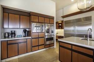Your gourmet kitchen features sleek wood cabinetry and top-tier stainless steel appliances for effortless cooking during your stay.