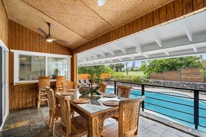 Vaulted ceilings overhead and water just beyond the lanai, where indoors meets out.