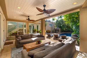 Relax in your private covered lanai with plush seating overlooking the sparkling pool and lush tropical garden.
