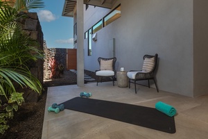 This private outdoor nook is the perfect space for relaxation and wellness, featuring comfortable seating and a dedicated yoga area.