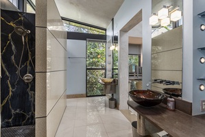 A stylish vanity area with warm wood accents and contemporary lighting.