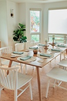 Gather around this beautifully styled dining table where your family meals become memorable moments with natural light streaming through large windows.