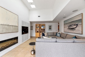 Well appointed, light and beachy decor with modern glass fireplace.