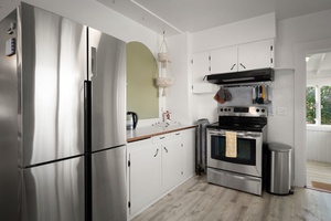 Cook comfortably in the bright kitchen with stainless steel appliances and easy flow.