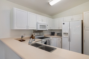 You'll love preparing meals in this bright, fully-equipped kitchen with modern appliances and ample counter space for all your culinary adventures.