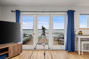 Your living room telescope awaits coastal discoveries through French doors to your private waterfront deck.