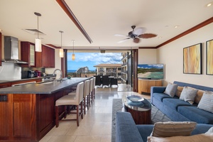 Relax in your open-concept living space where rich wood finishes meet ocean breezes through floor-to-ceiling doors opening to paradise.