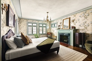 Guest suite with king bed, fireplace, and garden views.
