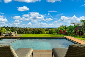 Dive into your private pool oasis with breathtaking views stretching across lush tropical landscapes to distant ocean glimpses.