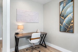 Dedicated workspace with desk and lamp for remote work or quiet moments.