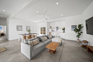 The living area features plush sofas, great for movie nights and quality time together.