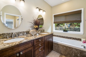 Spacious dual vanities in the primary en suite provide convenience and a spa-like experience.