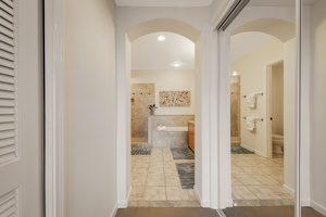 Primary suite luxury ensuite bathroom with a Jacuzzi tub, walk-in shower and dual vanity space.