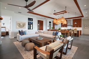 The elegant living and dining area features comfortable seating and warm wood accents.