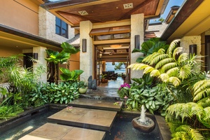 Tropical garden entrance with floating steps and Balinese-inspired design.