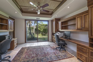 Stay productive in the dedicated office space with a desk, computer, and garden views.