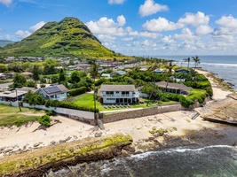Stunning oceanfront property nestled between dramatic mountains and pristine beaches in a tropical Hawaiian setting.