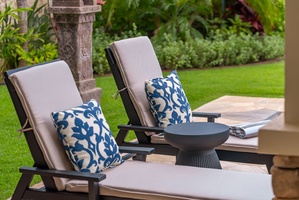 Lounge in your private garden retreat, with plush cushioned chairs and vibrant greenery surrounding you. Enjoy peaceful moments outdoors in comfort and style.
