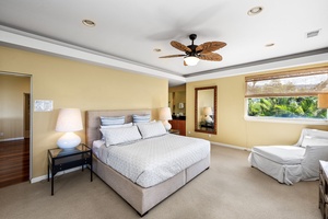 Serene bedroom featuring a king-sized bed, tasteful décor, and ample natural light.