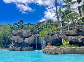 Cool off in our pool with waterfalls and lush palms.